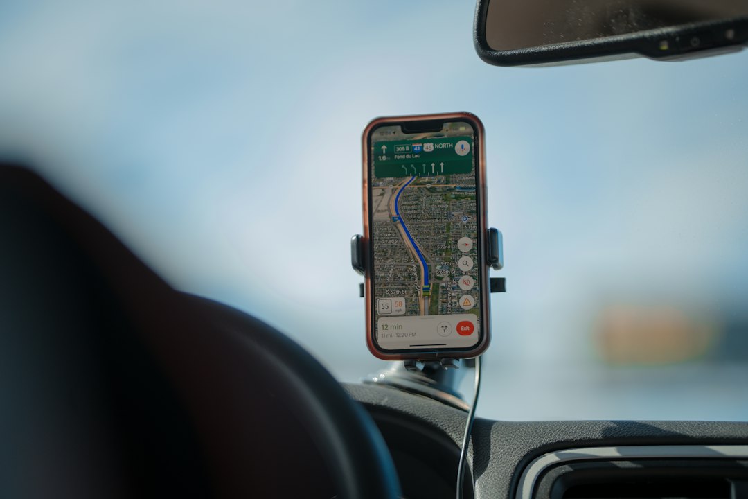 Perangkat navigasi GPS terpasang di dasbor mobil saat pengemudi melaju di jalan raya